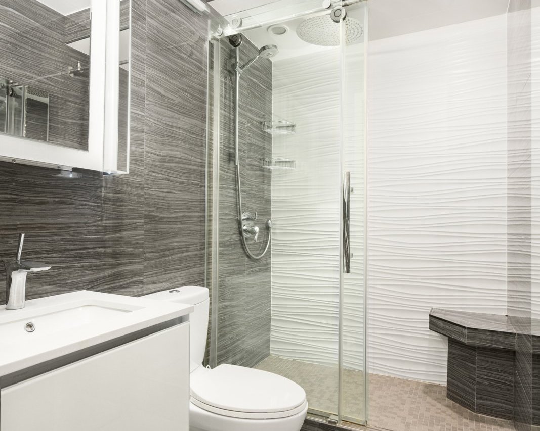 The renovated bath with glass rain shower